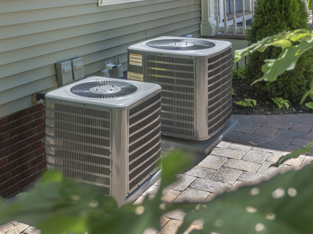 Two air conditioning units installed outside of a home